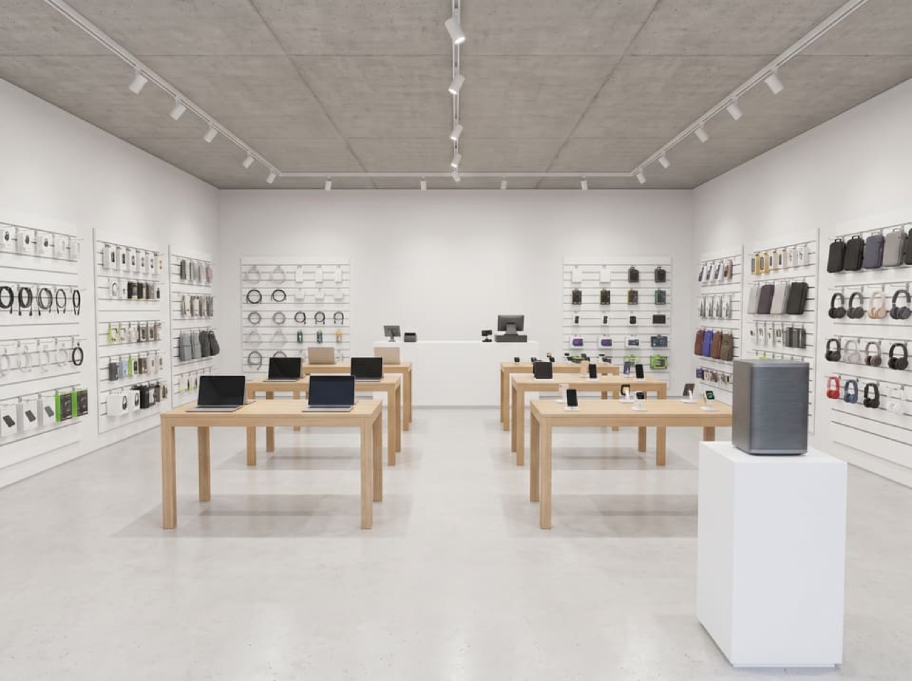 Input: bright electronics store with white walls, concrete ceiling, oak tables and wall displays of accessories